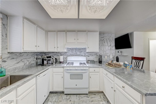 6735 W Charleston Blvd Unit 4, Las Vegas, NV 89146 - kitchen featuring white appliances, under cabinet range hood, a peninsula, and white cabinets