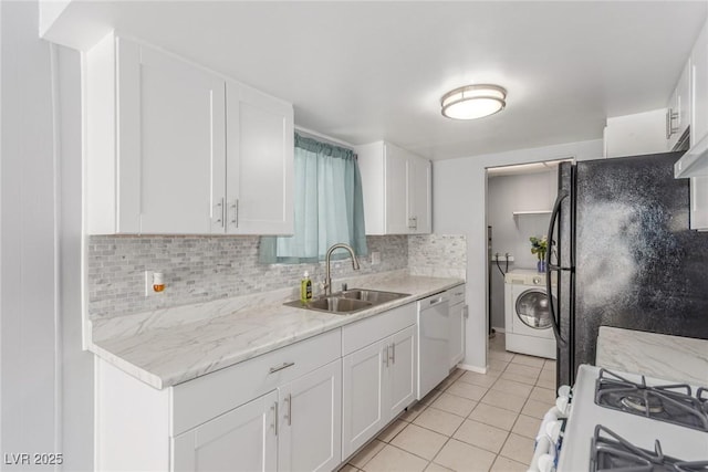 2432 Spanish Ct, Las Vegas, NV 89108 - kitchen featuring washer / clothes dryer, a sink, stainless steel dishwasher, light tile patterned floors, and tasteful backsplash