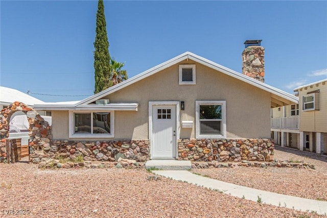 659 D Ave, Boulder City, NV 89005 - view of front of home with stucco siding, stone siding, and a chimney