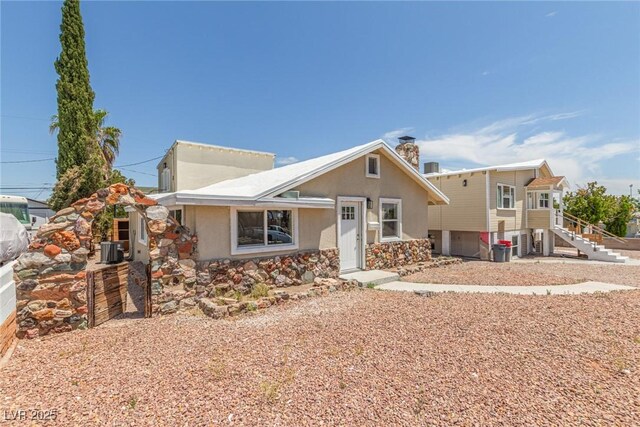 659 D Ave, Boulder City, NV 89005 - view of front of house featuring cooling unit, stucco siding, stairs, and a chimney