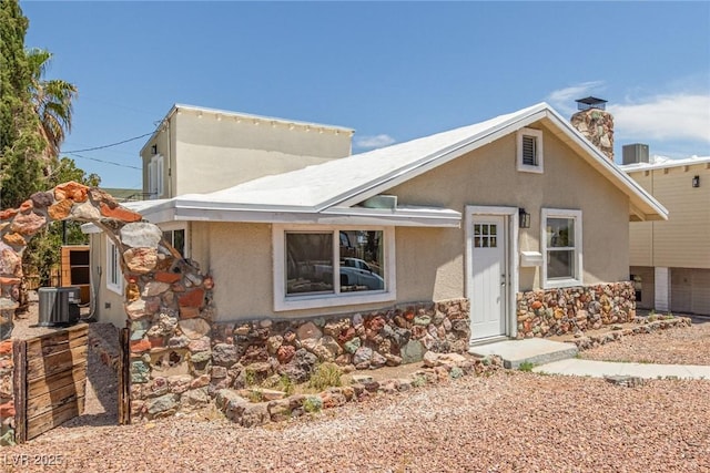 659 D Ave, Boulder City, NV 89005 - view of front of property featuring stucco siding, stone siding, central AC, and a chimney
