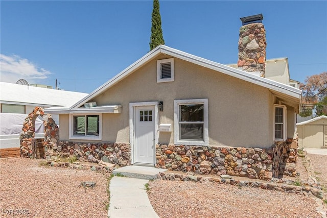 659 D Ave, Boulder City, NV 89005 - view of front facade with stone siding, stucco siding, and a chimney