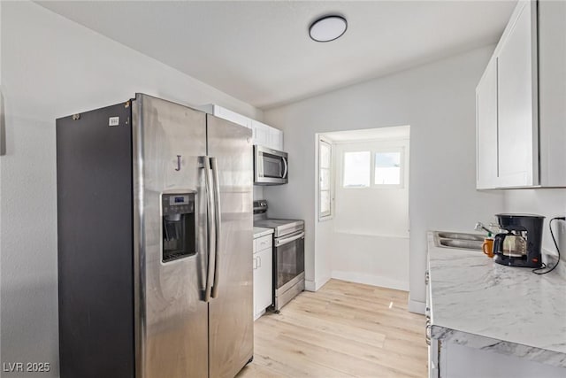659 D Ave, Boulder City, NV 89005 - kitchen featuring appliances with stainless steel finishes, a sink, light wood finished floors, light countertops, and white cabinets