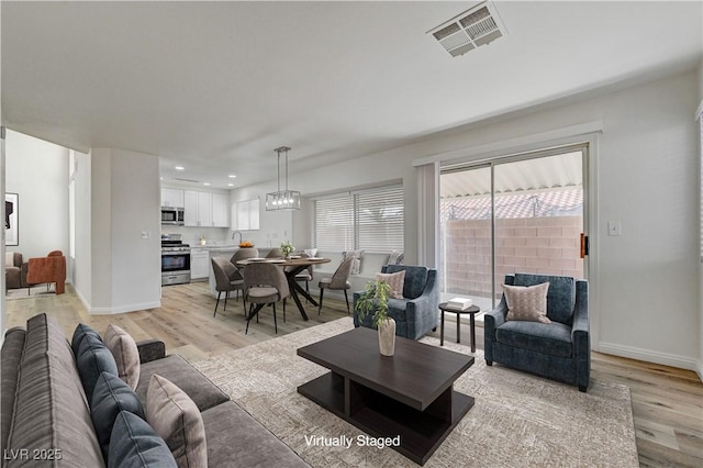 2573 Rafferty Creek Ln, Las Vegas, NV 89156 - living room with light wood-type flooring, recessed lighting, and baseboards