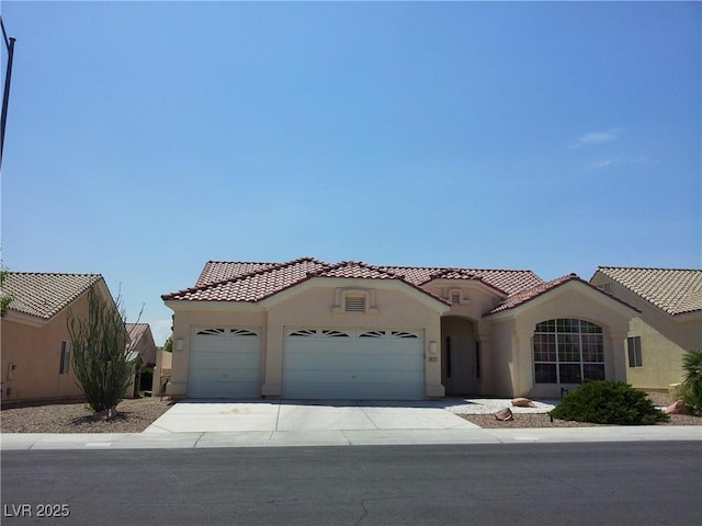 8545 Summer Vista Ave, Las Vegas, NV 89145 - mediterranean / spanish-style house with stucco siding, a garage, and a tiled roof