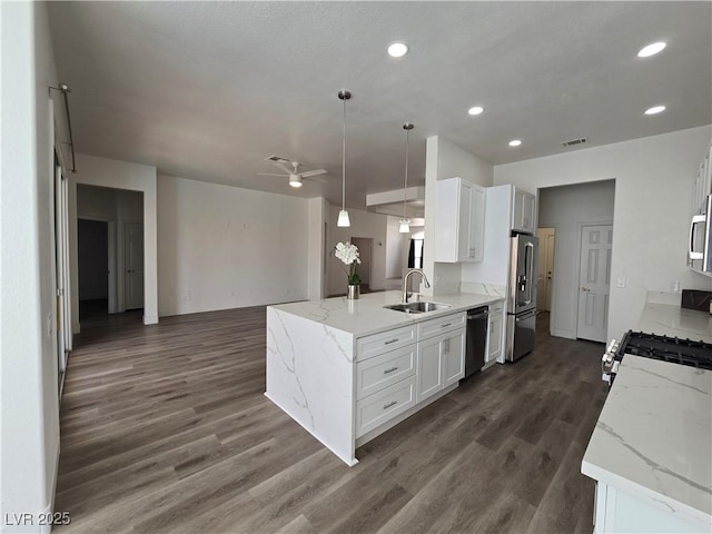 8545 Summer Vista Ave, Las Vegas, NV 89145 - kitchen with appliances with stainless steel finishes, a sink, open floor plan, dark wood finished floors, and white cabinetry