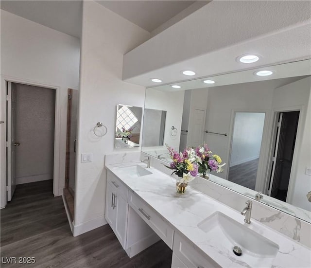 8545 Summer Vista Ave, Las Vegas, NV 89145 - bathroom featuring double vanity, baseboards, wood finished floors, and recessed lighting