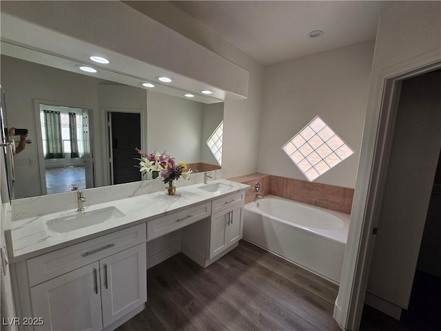 8545 Summer Vista Ave, Las Vegas, NV 89145 - full bath featuring a garden tub, double vanity, wood finished floors, and recessed lighting