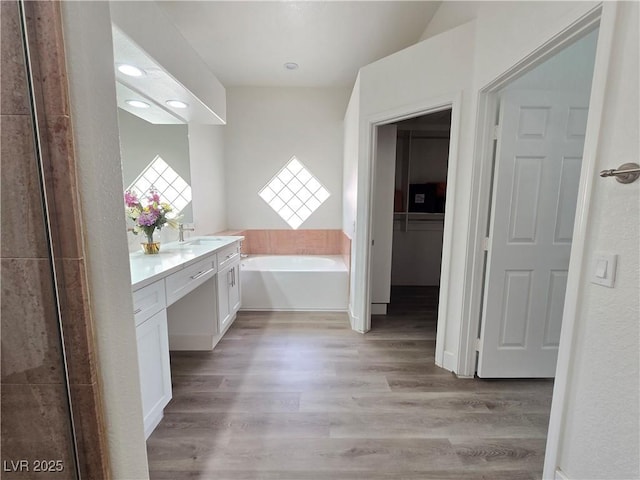 8545 Summer Vista Ave, Las Vegas, NV 89145 - bathroom featuring vanity, a bath, wood finished floors, and recessed lighting