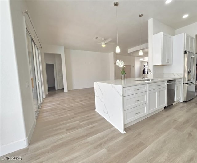 8545 Summer Vista Ave, Las Vegas, NV 89145 - kitchen with appliances with stainless steel finishes, a sink, white cabinets, a ceiling fan, and light wood-type flooring