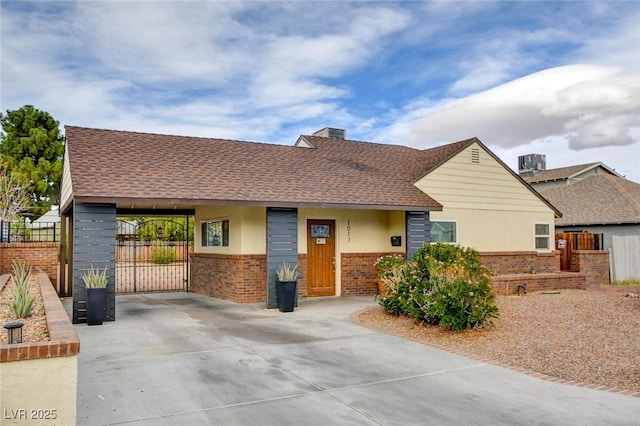 1017 E Oakey Blvd, Las Vegas, NV 89104 - ranch-style home featuring brick siding, a gate, roof with shingles, and driveway