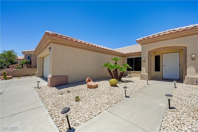 2545 Banora Point Dr, Las Vegas, NV 89134 - view of home's exterior with stucco siding, a tiled roof, and a garage