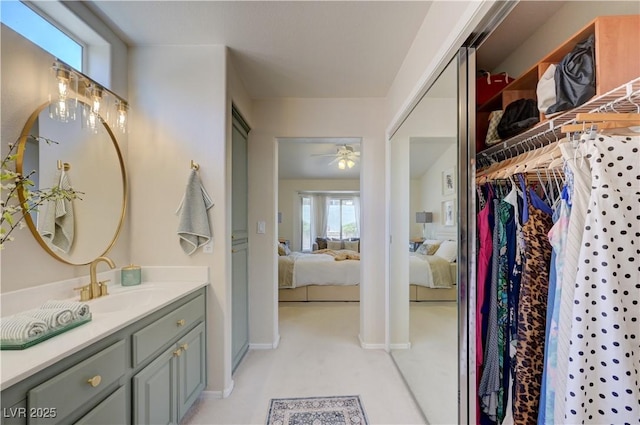 2545 Banora Point Dr, Las Vegas, NV 89134 - full bathroom featuring ensuite bath, vanity, ceiling fan, a walk in closet, and baseboards