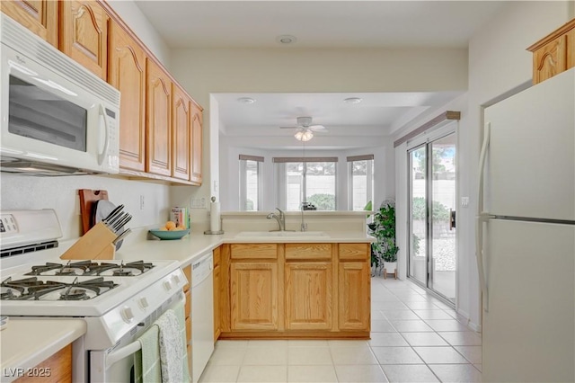 2545 Banora Point Dr, Las Vegas, NV 89134 - kitchen with white appliances, a sink, light countertops, ceiling fan, and light tile patterned floors