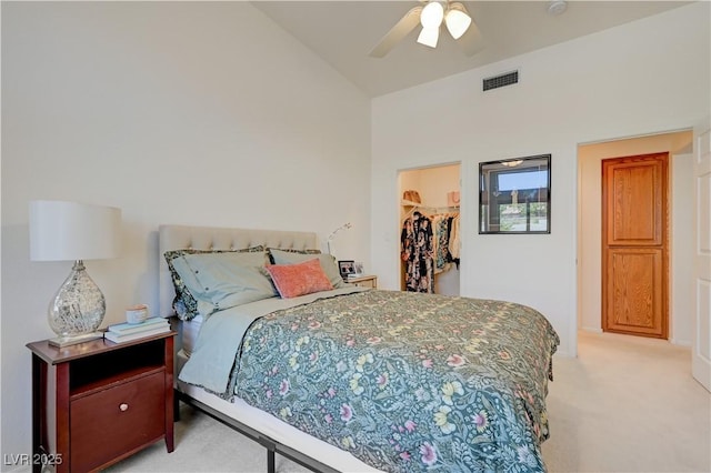 2545 Banora Point Dr, Las Vegas, NV 89134 - bedroom with light colored carpet, lofted ceiling, a spacious closet, a closet, and a ceiling fan