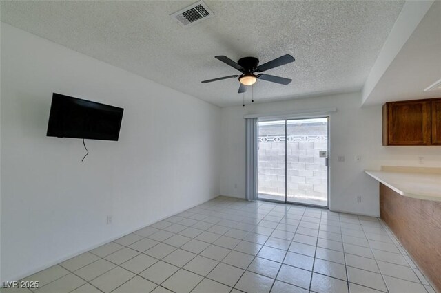 2116 Cameron St, Las Vegas, NV 89102 - unfurnished living room with a textured ceiling, ceiling fan, and light tile patterned flooring
