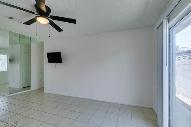 2116 Cameron St, Las Vegas, NV 89102 - unfurnished room featuring a textured ceiling, ceiling fan, and light tile patterned floors