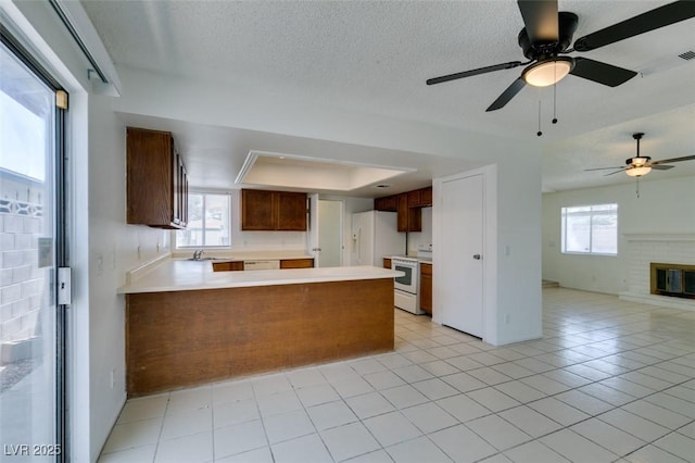 2116 Cameron St, Las Vegas, NV 89102 - kitchen featuring open floor plan, white appliances, a sink, light countertops, and a peninsula