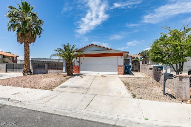 2116 Cameron St, Las Vegas, NV 89102 - single story home with brick siding, an attached garage, a fenced front yard, and concrete driveway