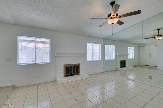 2116 Cameron St, Las Vegas, NV 89102 - unfurnished living room with a fireplace, ceiling fan, a textured ceiling, and tile patterned flooring