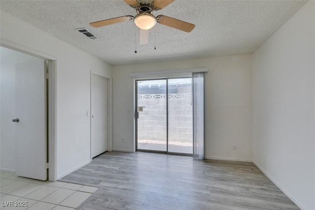 2116 Cameron St, Las Vegas, NV 89102 - spare room featuring light wood finished floors, a textured ceiling, a ceiling fan, and baseboards