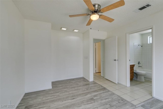 2116 Cameron St, Las Vegas, NV 89102 - empty room with a ceiling fan, a textured ceiling, and light tile patterned floors