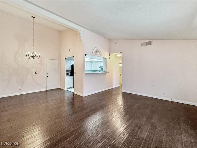 2204 Short Pine Dr, Las Vegas, NV 89108 - unfurnished living room featuring a chandelier, wood finished floors, vaulted ceiling, and baseboards