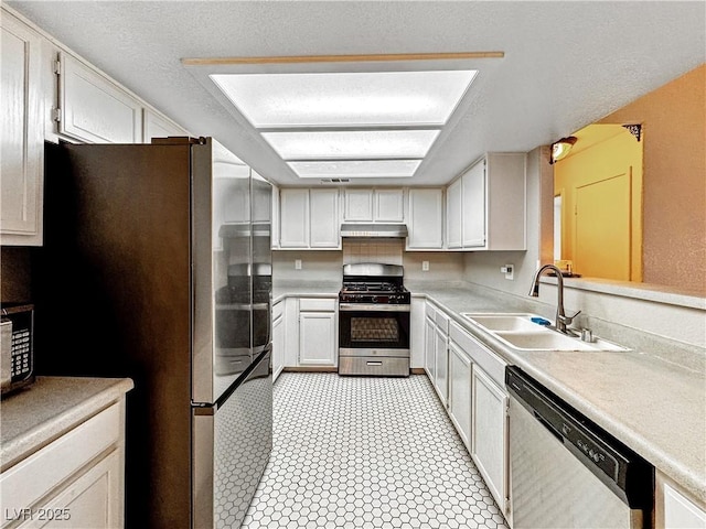 2204 Short Pine Dr, Las Vegas, NV 89108 - kitchen with stainless steel appliances, a sink, under cabinet range hood, and light countertops