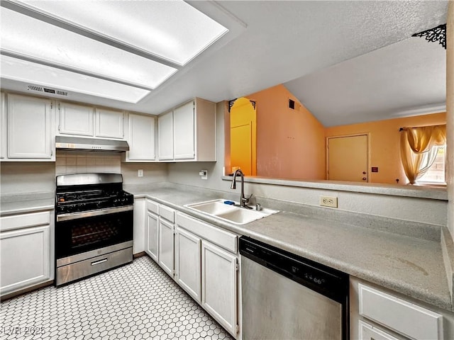 2204 Short Pine Dr, Las Vegas, NV 89108 - kitchen with appliances with stainless steel finishes, a sink, under cabinet range hood, vaulted ceiling, and light countertops