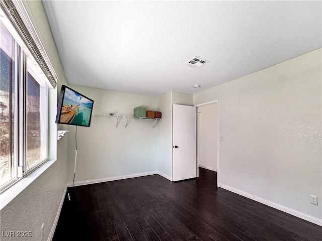 2204 Short Pine Dr, Las Vegas, NV 89108 - spare room featuring dark wood finished floors, baseboards, and a textured ceiling