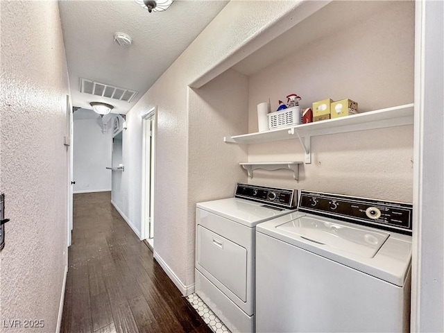 2204 Short Pine Dr, Las Vegas, NV 89108 - laundry room with washer and clothes dryer, a textured wall, dark wood-style floors, and baseboards