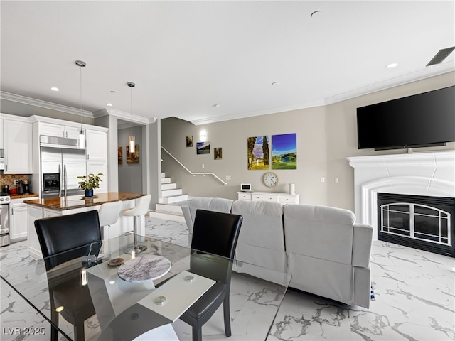 30 Via Vasari Unit 103, Henderson, NV 89011 - living area with light marble finish flooring, ornamental molding, stairs, recessed lighting, and a glass covered fireplace