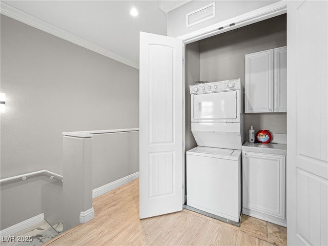 30 Via Vasari Unit 103, Henderson, NV 89011 - laundry area with stacked washer / dryer, crown molding, light wood-style floors, and baseboards