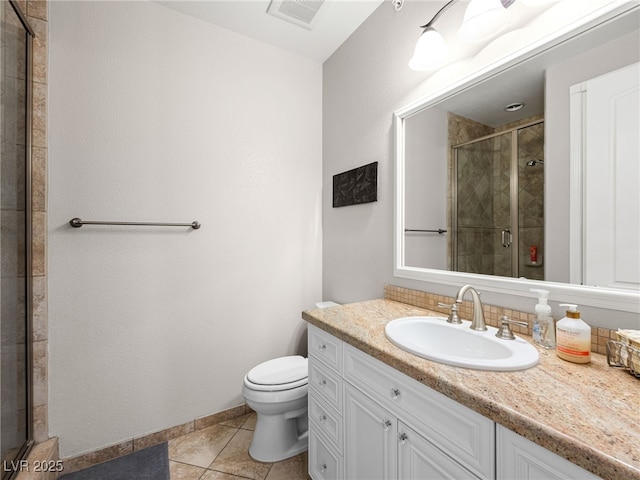 30 Via Vasari Unit 103, Henderson, NV 89011 - bathroom with vanity, toilet, a shower stall, tile patterned flooring, and baseboards