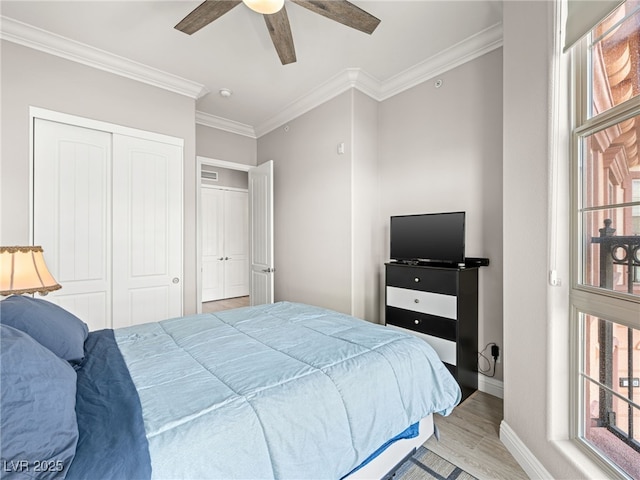 30 Via Vasari Unit 103, Henderson, NV 89011 - bedroom with ornamental molding, multiple windows, baseboards, wood finished floors, and a closet