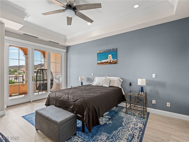30 Via Vasari Unit 103, Henderson, NV 89011 - bedroom featuring a tray ceiling, access to outside, ornamental molding, wood finished floors, and baseboards