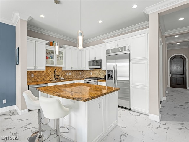 30 Via Vasari Unit 103, Henderson, NV 89011 - kitchen with stainless steel appliances, light marble finish floors, baseboards, white cabinets, and a sink