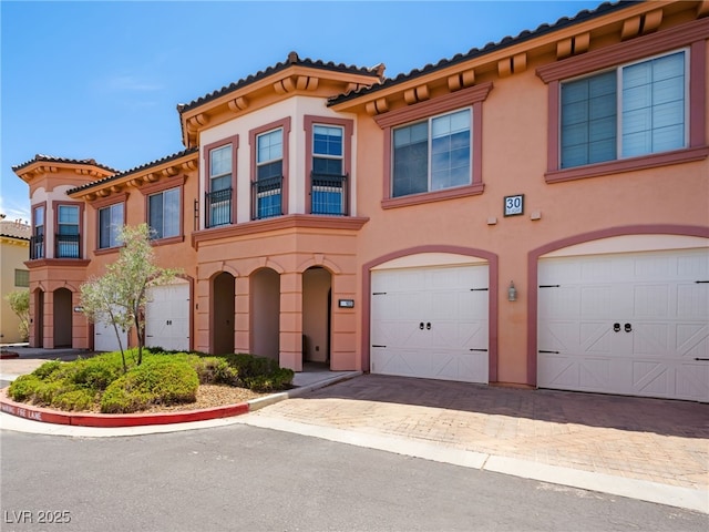 30 Via Vasari Unit 103, Henderson, NV 89011 - townhome / multi-family property with a garage, stucco siding, and driveway