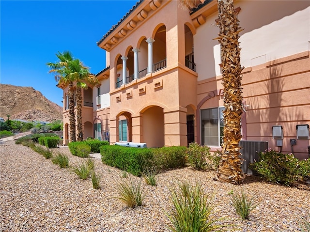 30 Via Vasari Unit 103, Henderson, NV 89011 - view of front of property with central AC, stucco siding, and a mountain view