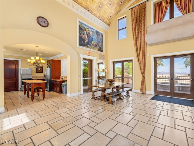 30 Via Vasari Unit 103, Henderson, NV 89011 - dining room featuring french doors, baseboards, a chandelier, healthy amount of natural light, and high vaulted ceiling