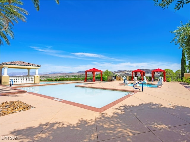 30 Via Vasari Unit 103, Henderson, NV 89011 - community pool featuring a gazebo, a mountain view, and a patio