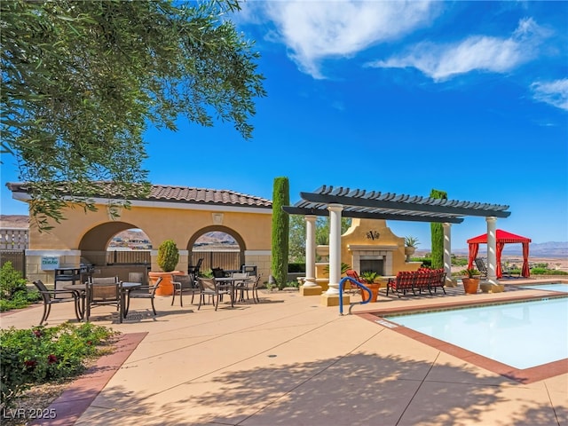30 Via Vasari Unit 103, Henderson, NV 89011 - swimming pool featuring an outdoor fireplace, a patio area, a pergola, and outdoor dining area