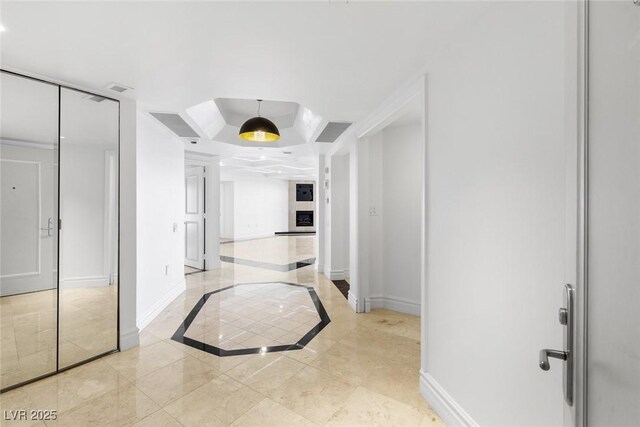 2777 Paradise Rd Unit 303, Las Vegas, NV 89109 - hallway featuring inlaid floor details, a raised ceiling, and baseboards