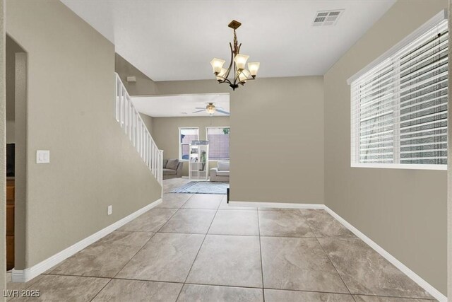 8015 Maple Park St, Las Vegas, NV 89131 - unfurnished dining area featuring a ceiling fan, stairway, a chandelier, tile patterned floors, and baseboards