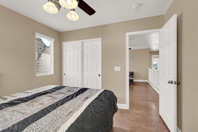 8015 Maple Park St, Las Vegas, NV 89131 - bedroom featuring baseboards, wood finished floors, a closet, and a ceiling fan