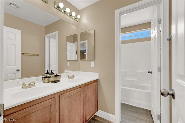 8015 Maple Park St, Las Vegas, NV 89131 - bathroom with double vanity, wood finished floors, and washtub / shower combination