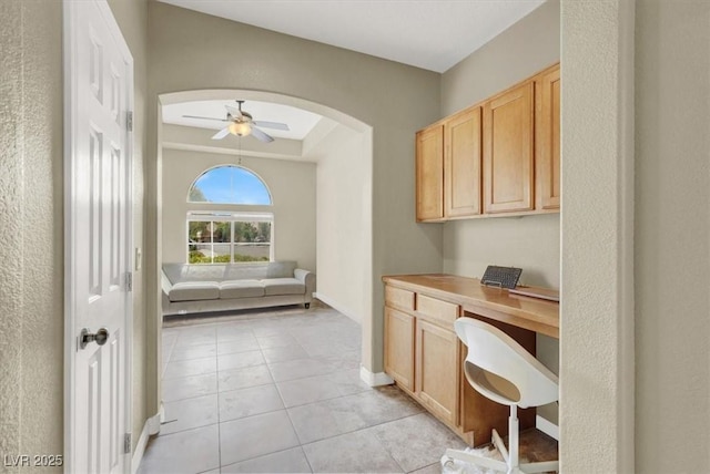 8015 Maple Park St, Las Vegas, NV 89131 - office with arched walkways, light tile patterned floors, ceiling fan, built in study area, and baseboards