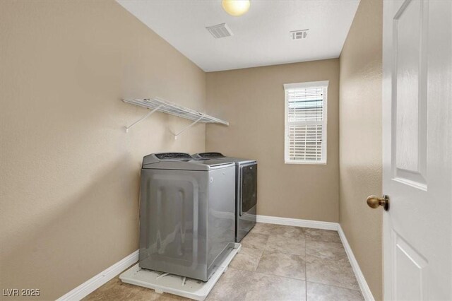 8015 Maple Park St, Las Vegas, NV 89131 - laundry room with washing machine and clothes dryer, baseboards, and light tile patterned floors