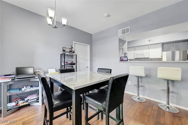 6650 W Warm Springs Rd Unit 1083, Las Vegas, NV 89118 - dining area with wood finished floors, baseboards, and a chandelier