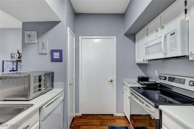 6650 W Warm Springs Rd Unit 1083, Las Vegas, NV 89118 - kitchen featuring white appliances, light countertops, and dark wood-style flooring